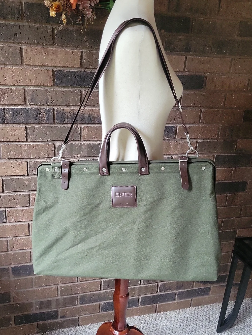 Line of Trade green military duffle sack with brown canvas strap